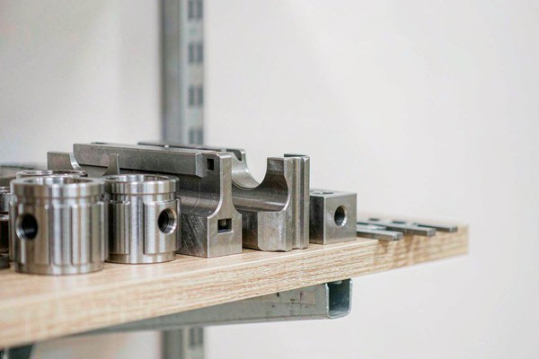 Several hardened steel coin dies and molds stored on a factory shelf awaiting future reorders