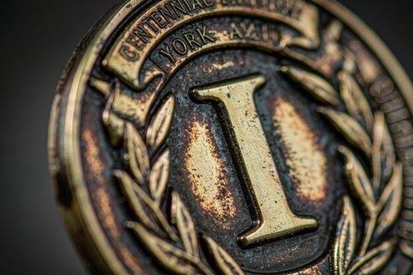 Antique gold challenge coin patina finish showing recessed shadows and high relief metal details