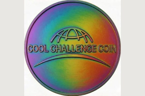 Iridescent chameleon rainbow finish on a custom challenge coin reflecting multi-colored metallic hues
